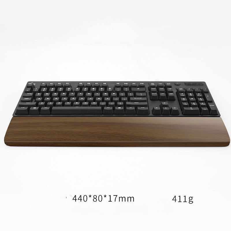 Long walnut wrist rest before a full-size black keyboard, sized 440x80x17mm at 411g – Pausadesk