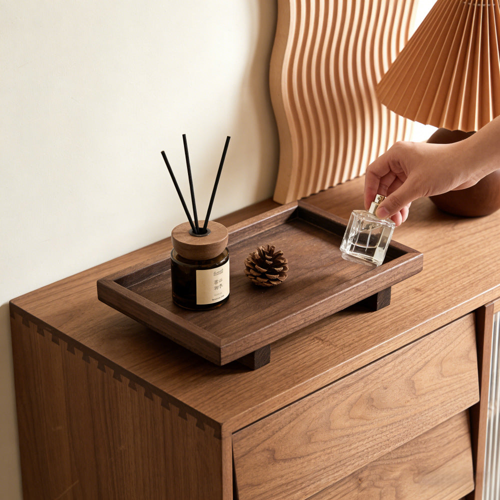 Dark walnut desk tray on a dresser with a reed diffuser, pinecone and glass perfume bottle – Pausadesk