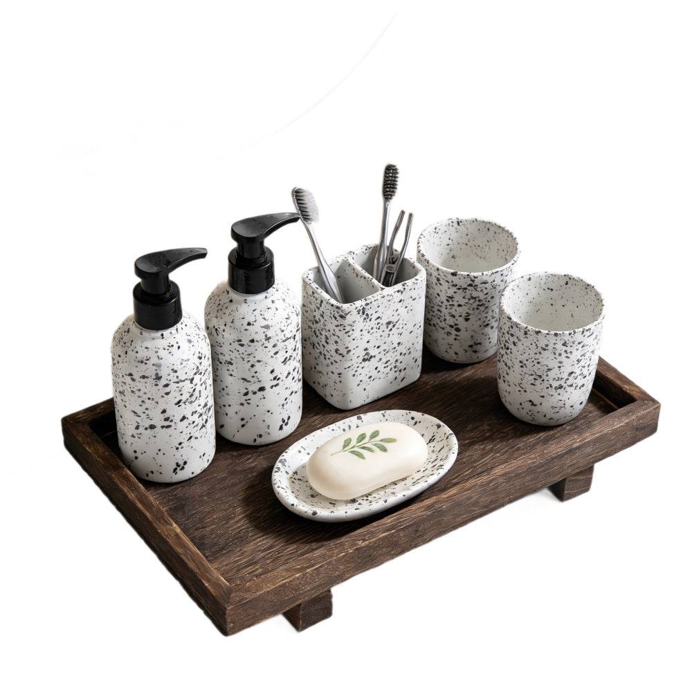 Dark wood tray with speckled ceramic soap dispensers, toothbrush cup and soap dish on white – Pausadesk